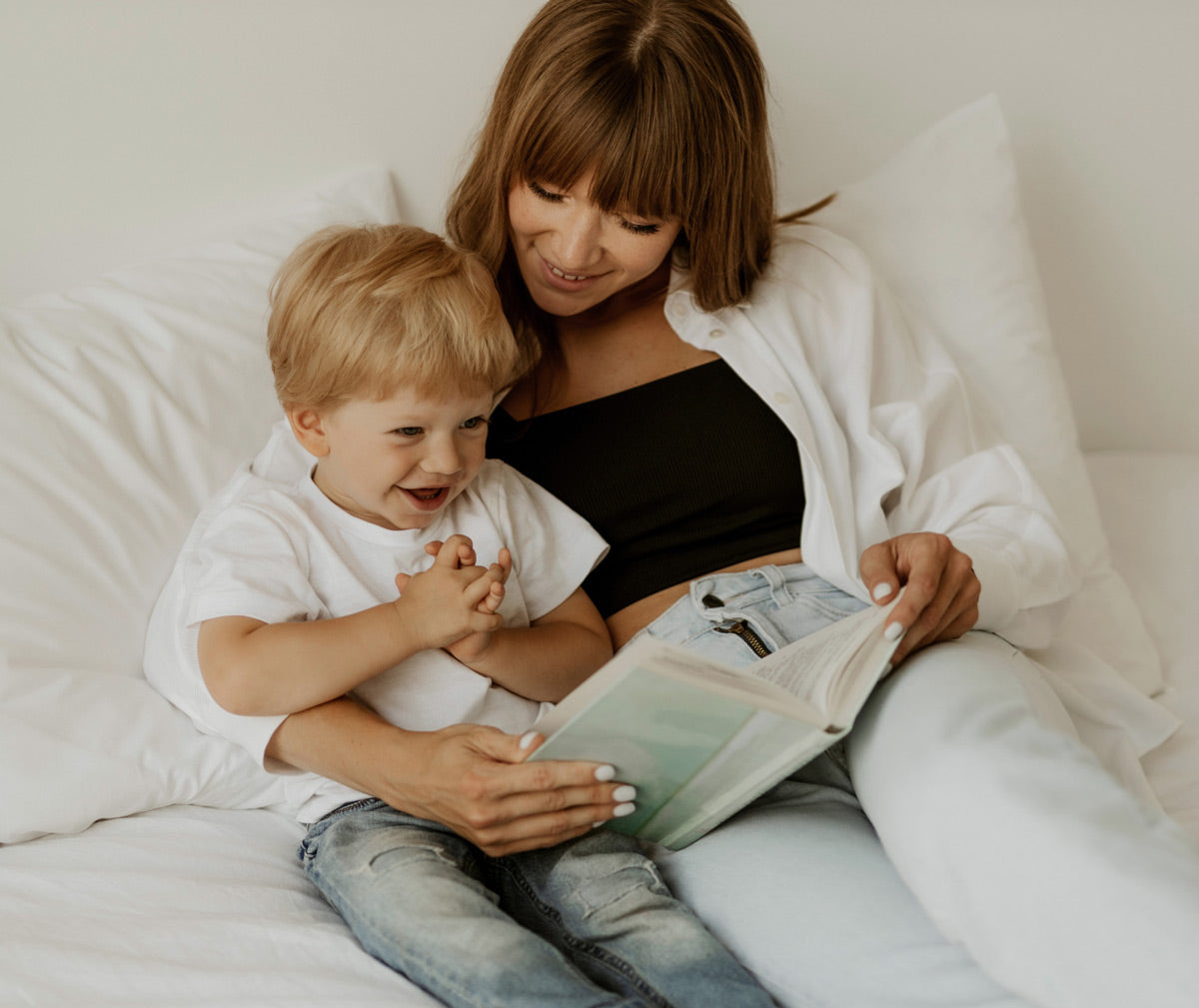mommy on bed reading to her son bedtime stories